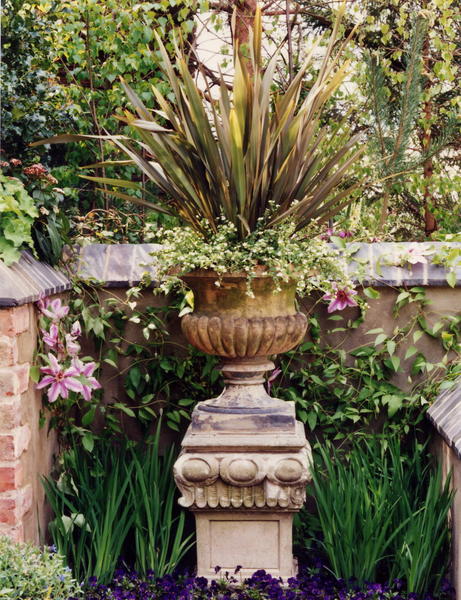 Stone urn planetd with Phormium and Bacopa